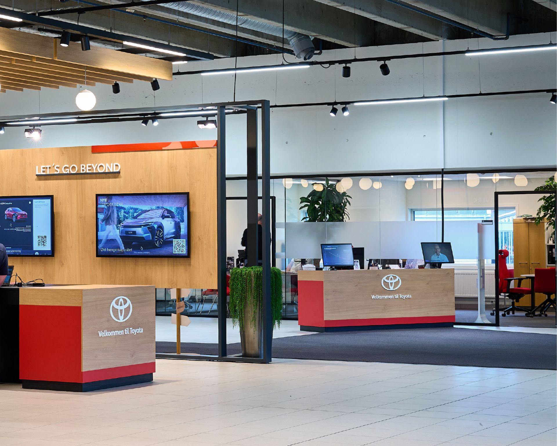 Toyota showroom with interactive screens and digital tools for customer interaction.