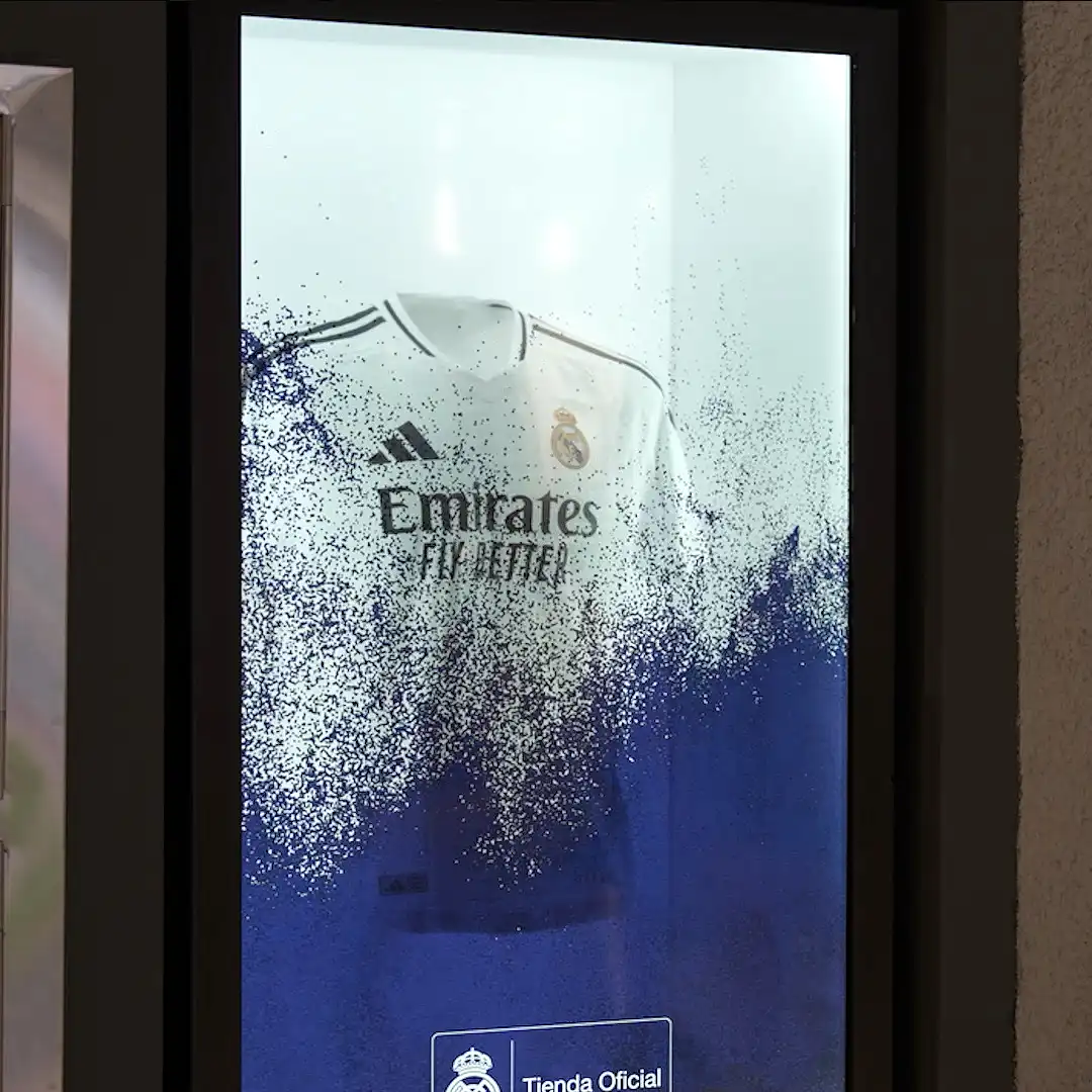3D dragon projection and holographic vitrine showcasing Real Madrid jersey in immersive fan experience inside Santiago Bernabéu Stadium.