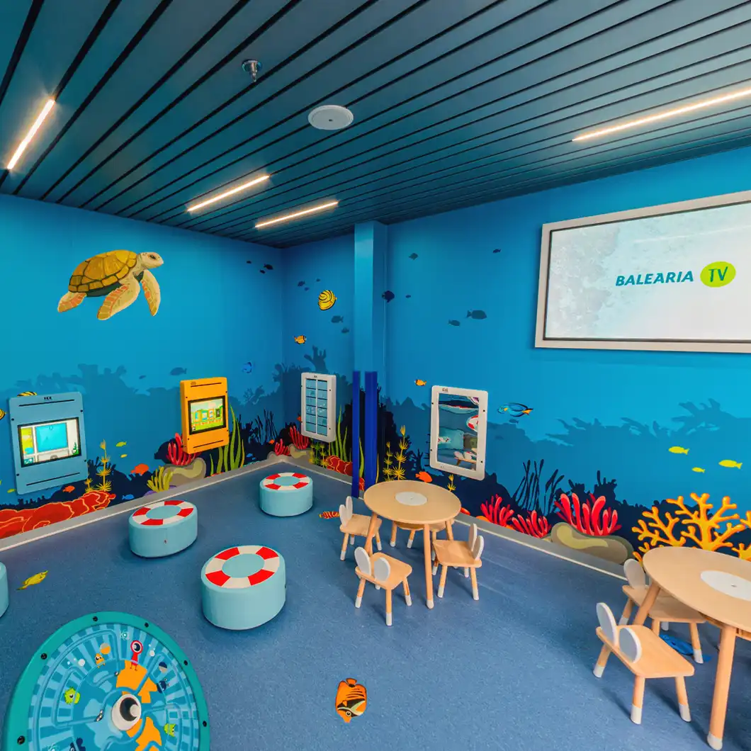 Children playing in an interactive area with digital screens aboard BALEÀRIA’s Eleanor Roosevelt ferry.