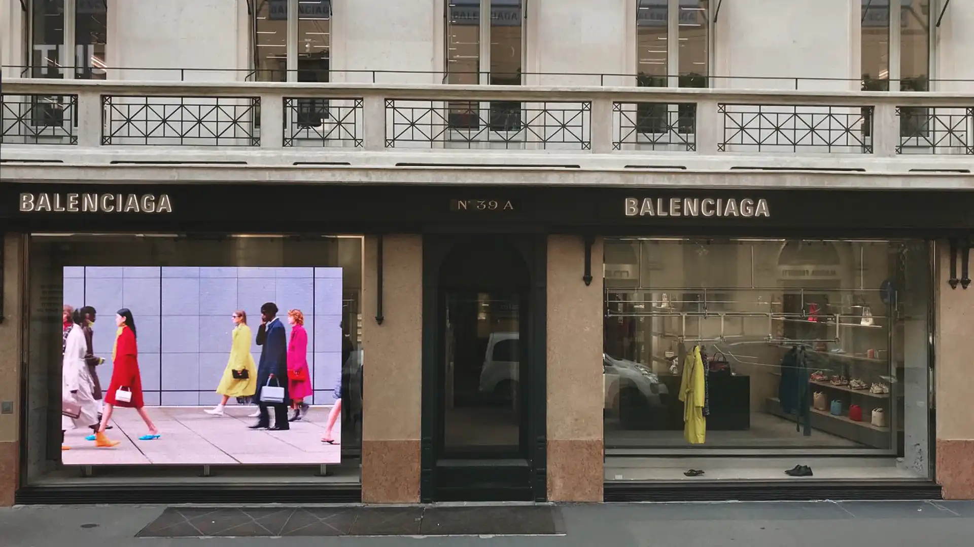 Exterior view of Balenciaga’s Milan flagship store featuring large-format LED screen integrated into the minimalist façade.
