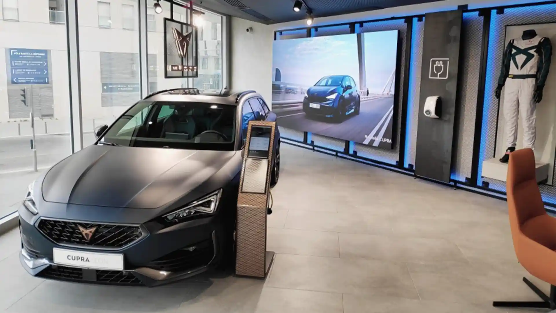 Exterior view of CUPRA City Garage Paris featuring LED screen and immersive brand visuals