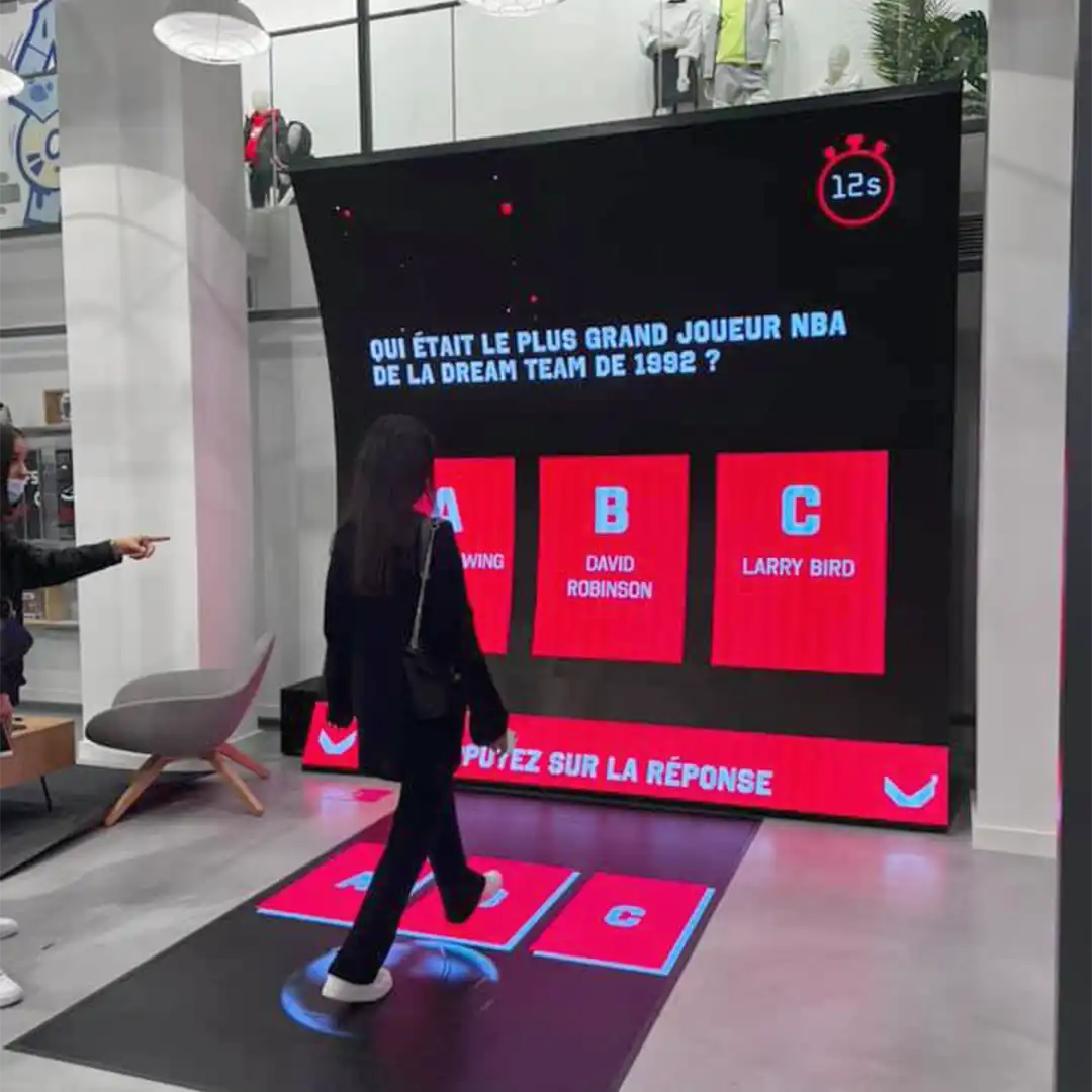 Striper Quiz interactive game with LED floor and basket challenge at Foot Locker Paris.