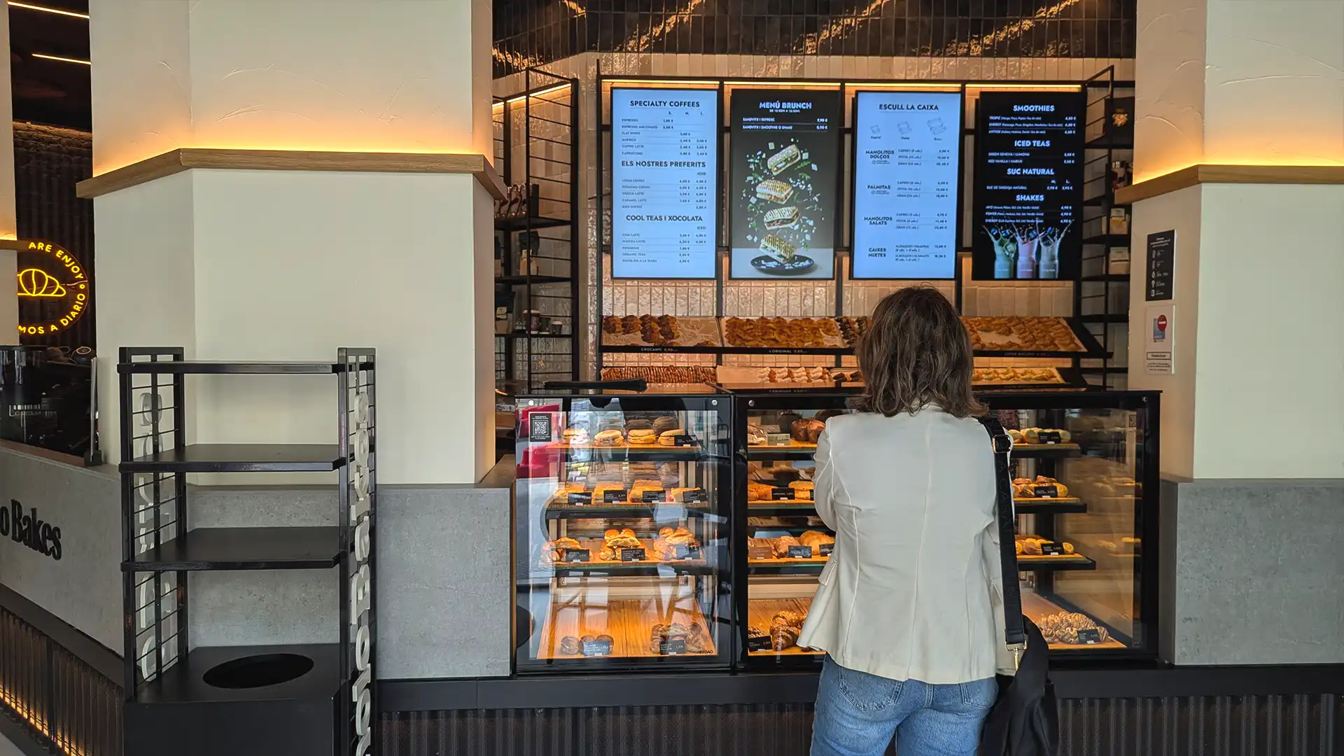 Digital display at Manolo Bakes store showing promotional and product content integrated by TRISON.