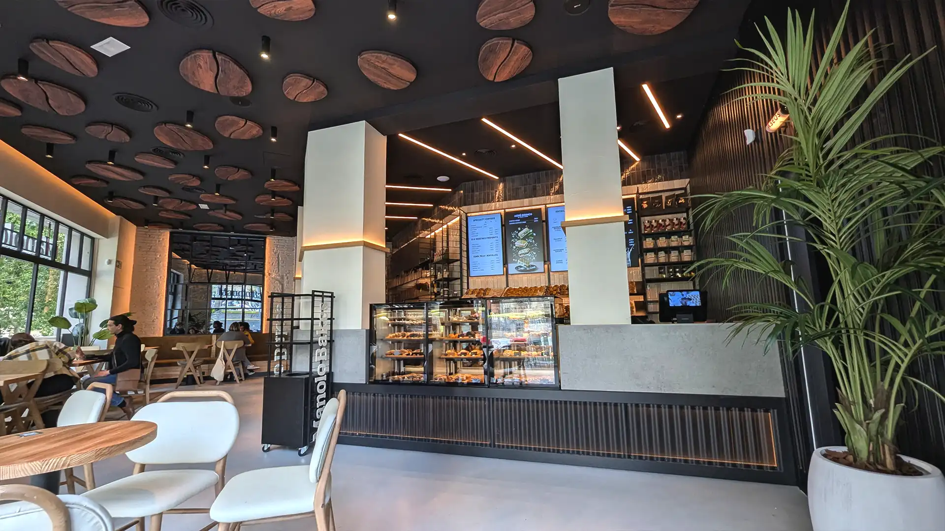 Storefront LED display at Manolo Bakes used to attract customers and showcase digital content managed by TRISON.