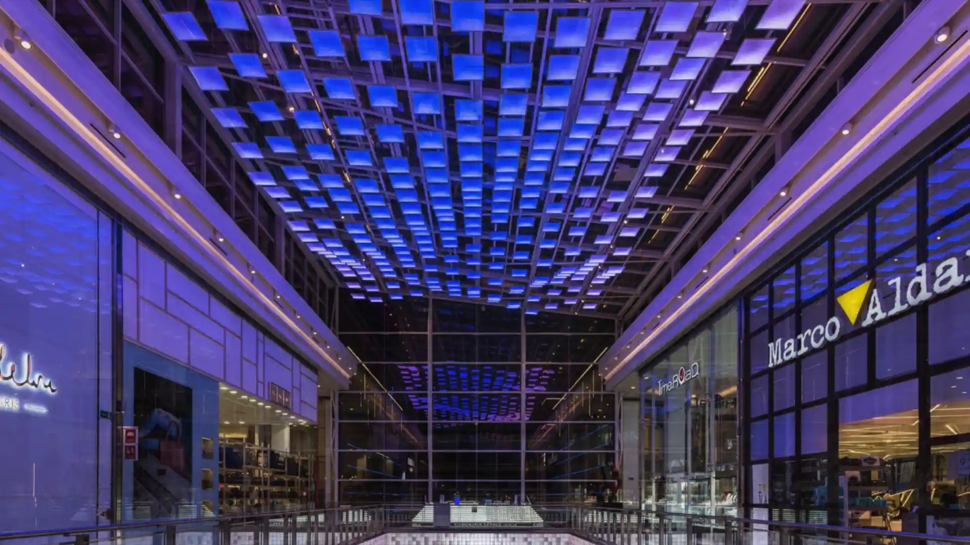 Immersive digital art installations integrated into the architecture of Plaza Río 2 shopping centre in Madrid.