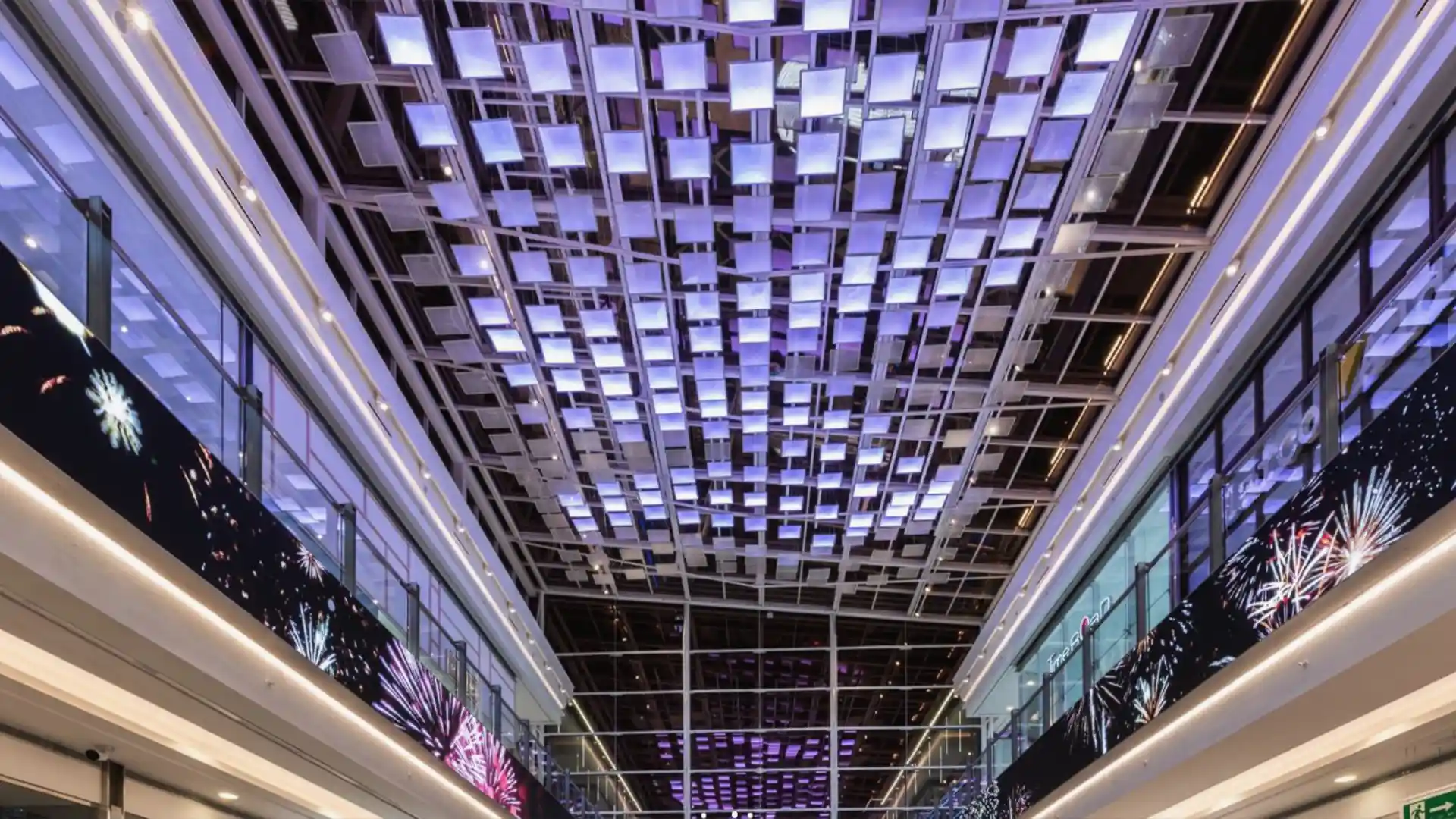 Semi-transparent LED screens and digital pillars integrated into the architecture of Plaza Río 2 shopping centre.