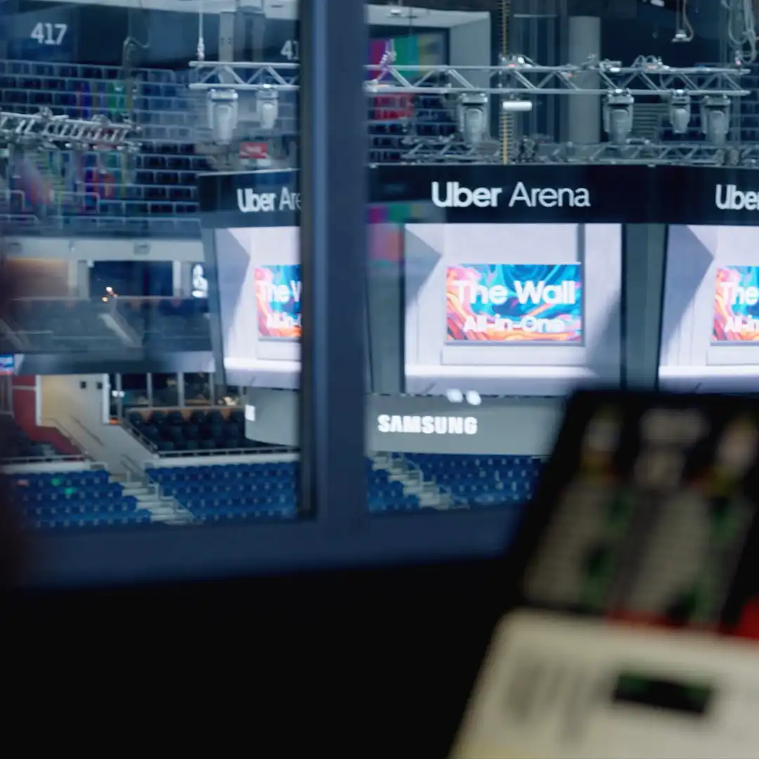 Panoramic LED ring under the scoreboard showcasing animated visuals during a sports event.