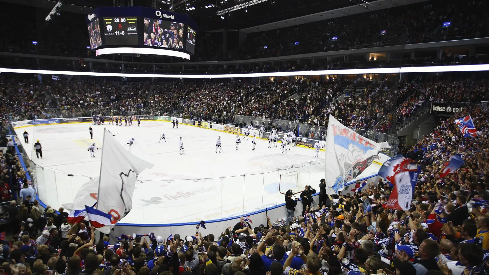 Technicians assembling large-format LED panels at Uber Arena during the installation phase.